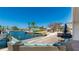 Waterfront patio view of a house with a hot tub, outdoor seating area, and an unobstructed view of the waterway at 10008 Spoonbill E Rd, Bradenton, FL 34209