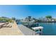 Waterfront backyard view with boat dock, boat lift and seating area in a serene outdoor environment at 10008 Spoonbill E Rd, Bradenton, FL 34209