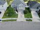 An aerial view of a gray home with well-maintained landscaping and a long driveway at 10934 79Th E St, Parrish, FL 34219