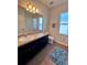 Bathroom featuring a vanity with dark cabinets, toilet, mirror and tiled floors at 10934 79Th E St, Parrish, FL 34219