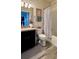 Bathroom showcasing a modern vanity with dark cabinets, tiled floors, toilet and shower/tub at 10934 79Th E St, Parrish, FL 34219