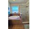 Beautiful bathroom featuring a soaking tub, glass-enclosed shower, and tranquil ambiance for ultimate relaxation at 10934 79Th E St, Parrish, FL 34219
