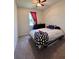 A cozy bedroom featuring a ceiling fan and a comfortable-looking queen-size bed with a ghost-themed blanket at 10934 79Th E St, Parrish, FL 34219