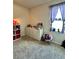 Cozy bedroom with a dresser, window, and carpeted floors, perfect for relaxation and rest at 10934 79Th E St, Parrish, FL 34219