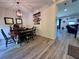 Dining room with stylish lighting, table and chairs and access to the living room at 10934 79Th E St, Parrish, FL 34219