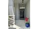 Inviting entryway with a black door, decorative wreath, stone accents, and a potted plant at 10934 79Th E St, Parrish, FL 34219
