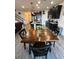 Open floor plan with kitchen island, dark cabinets, stainless appliances, and dining area at 10934 79Th E St, Parrish, FL 34219