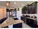 Updated kitchen with granite counters, stainless appliances, large island, and dark wood cabinetry at 10934 79Th E St, Parrish, FL 34219