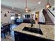 Spacious kitchen island features a dark sink and stylish faucet, with open-concept views of the living area at 10934 79Th E St, Parrish, FL 34219