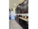 Modern kitchen features stainless steel appliances, granite countertops, and dark wood cabinets at 10934 79Th E St, Parrish, FL 34219