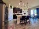 Modern kitchen with dark cabinets, granite counters, stainless steel appliances, and an island with seating at 10934 79Th E St, Parrish, FL 34219
