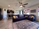 Open concept living room showcasing kitchen with granite countertops, large island, and breakfast bar at 10934 79Th E St, Parrish, FL 34219
