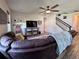 Inviting living room with comfortable seating, a ceiling fan, and natural light, perfect for relaxation and entertainment at 10934 79Th E St, Parrish, FL 34219