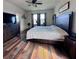 Large bedroom with lots of natural light, hardwood floors, and comfortable furnishings, perfect for relaxation at 10934 79Th E St, Parrish, FL 34219