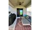 Outdoor patio with comfortable seating, ceiling fan, BBQ, and sliding glass doors to the home's interior at 10934 79Th E St, Parrish, FL 34219