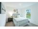 Cozy bedroom featuring neutral decor, a comfortable bed, and a view of the outdoors at 1098 Fletcher St, Port Charlotte, FL 33952