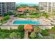 Aerial view of the pool with palm trees, sun loungers and manicured landscaping at 1241 Gulf Of Mexico Dr # 603, Longboat Key, FL 34228