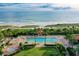 Beautiful aerial view of the pool, tropical landscaping, and ocean at 1241 Gulf Of Mexico Dr # 603, Longboat Key, FL 34228