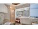 Unique bathroom with an ornate vanity, large mirror, walk-in shower, and bidet at 1241 Gulf Of Mexico Dr # 603, Longboat Key, FL 34228