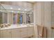 Bright bathroom with vanity and large mirror, with a view into another bathroom at 1241 Gulf Of Mexico Dr # 603, Longboat Key, FL 34228