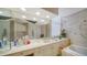 Well-lit bathroom with double mirror, vanity, and soaking tub next to a window at 1241 Gulf Of Mexico Dr # 603, Longboat Key, FL 34228