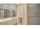Bright bathroom with vanity, large mirror, gold fixtures and a glass shower at 1241 Gulf Of Mexico Dr # 603, Longboat Key, FL 34228