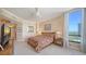 Comfortable bedroom with a wooden bed frame, bedside tables, and a window overlooking the ocean at 1241 Gulf Of Mexico Dr # 603, Longboat Key, FL 34228