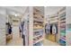 Spacious walk-in closet with ample storage, shelving, and hanging space for clothes and accessories at 1241 Gulf Of Mexico Dr # 603, Longboat Key, FL 34228