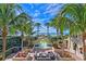 Courtyard with a water fountain, comfortable seating, lush landscaping, and ocean views at 1241 Gulf Of Mexico Dr # 603, Longboat Key, FL 34228