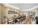 Dining area with a view, features a large table, wood floors, and bright, neutral paint at 1241 Gulf Of Mexico Dr # 603, Longboat Key, FL 34228