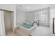 Relaxing hot tub room featuring an elegant glass block window, shower, and tile flooring at 1241 Gulf Of Mexico Dr # 603, Longboat Key, FL 34228