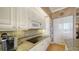 A kitchen with custom cabinets and a cooktop at 1241 Gulf Of Mexico Dr # 603, Longboat Key, FL 34228