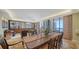 Bright living room featuring a dining area, ocean view, and decorative built-in shelving at 1241 Gulf Of Mexico Dr # 603, Longboat Key, FL 34228