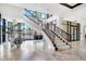 Elegant lobby with staircase, marble floors, large windows, and views of outdoor seating areas at 1241 Gulf Of Mexico Dr # 603, Longboat Key, FL 34228