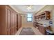 Bright home office featuring custom built-ins, hardwood floors, and a large window with scenic views at 1241 Gulf Of Mexico Dr # 603, Longboat Key, FL 34228
