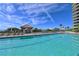 Community pool with sun loungers and poolside cabana with ocean view at 1241 Gulf Of Mexico Dr # 603, Longboat Key, FL 34228