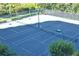 Well-maintained tennis court surrounded by lush greenery, perfect for recreational play at 1241 Gulf Of Mexico Dr # 603, Longboat Key, FL 34228
