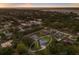 Scenic aerial shot captures a single Gathering home with pool nestled among many other homes and lush trees near the water at 1411 70Th Nw St, Bradenton, FL 34209