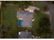 Stunning aerial shot of home with screened in-ground pool, lush lawn, and long driveway at 1411 70Th Nw St, Bradenton, FL 34209