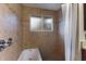 Bathroom featuring tiled shower, showerhead, bathtub, and tile flooring at 1411 70Th Nw St, Bradenton, FL 34209