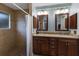 Bathroom boasts double sinks, framed mirrors, updated lighting and a tiled walk-in shower at 1411 70Th Nw St, Bradenton, FL 34209