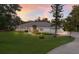 Beautiful single-story home featuring manicured lawn, mature landscaping, and a winding driveway at 1411 70Th Nw St, Bradenton, FL 34209