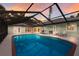 Screened pool area with outdoor dining, ideal for gatherings under the evening sky at 1411 70Th Nw St, Bradenton, FL 34209
