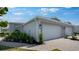 Charming villa exterior features a two car garage, brick paver driveway and beautiful landscaping at 16114 Ivy Ridge Ct, Port Charlotte, FL 33953