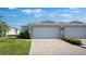 Charming home featuring a two-car garage, beautiful brick driveway, and manicured landscaping at 16114 Ivy Ridge Ct, Port Charlotte, FL 33953