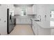 Bright kitchen with stainless steel appliances, white cabinets, and expansive counter space at 16114 Ivy Ridge Ct, Port Charlotte, FL 33953