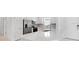 Well-lit kitchen showcasing stainless steel appliances, a central island, and sleek white cabinetry at 16114 Ivy Ridge Ct, Port Charlotte, FL 33953