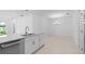 Modern kitchen with an island, stainless steel dishwasher, and an open floor plan at 16114 Ivy Ridge Ct, Port Charlotte, FL 33953