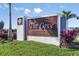 The Cove at West Port's welcome sign features detailed craftsmanship and colorful landscaping at 16114 Ivy Ridge Ct, Port Charlotte, FL 33953