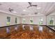 Spacious yoga studio features wood floors, natural light, and mirrored walls for a serene fitness experience at 16114 Ivy Ridge Ct, Port Charlotte, FL 33953